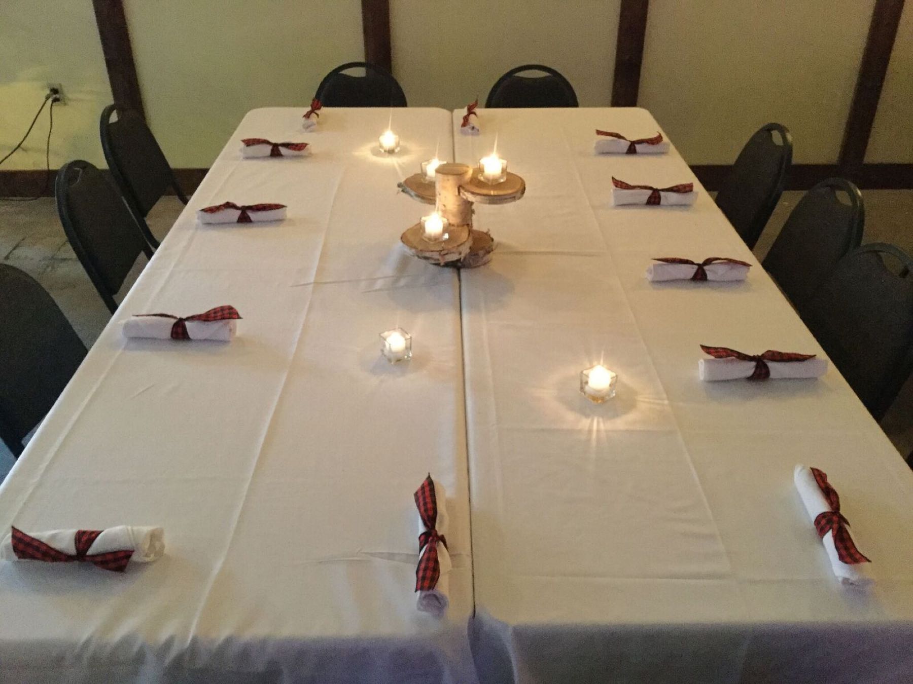 Long banquet table set with candles in the Event Center