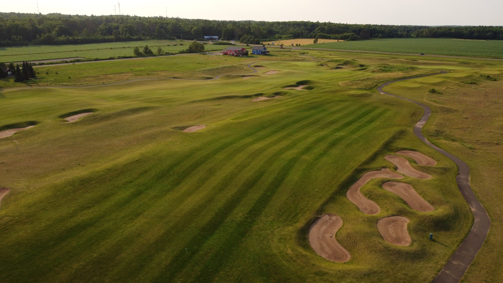 Fairway with winding bunkers and a cart path